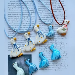 Macro detail view of several cute Nordic style duck pendants with floral and ribbon patterns.