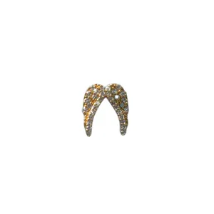 Sparkling gold angel wing jewelry charm encrusted with small crystals on a plain white background