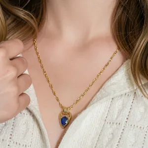 Close-up of elegant 18K gold-plated horseshoe necklace with blue waterdrop zircon