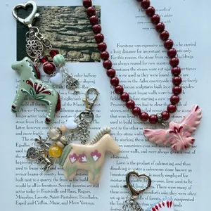 Handcrafted Nordic style animal charms and beaded necklace on magazine background.