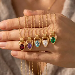 Detailed view of teardrop zircon necklaces with gold horseshoe clasps in multiple colors