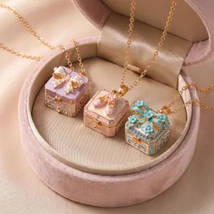 Detailed view of three fairytale-style locket necklaces with bows and ballet shoes
