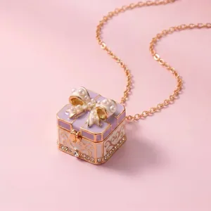 Detail view of purple gift box necklace pendant with pearl bow and rhinestones