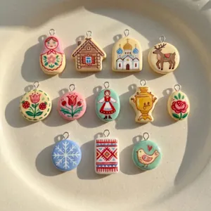 Detailed view of assorted folk art resin pendants featuring flowers, animals, and houses.