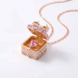 Macro detail of fairy tale openable box pendant with heart gem and pearl bow