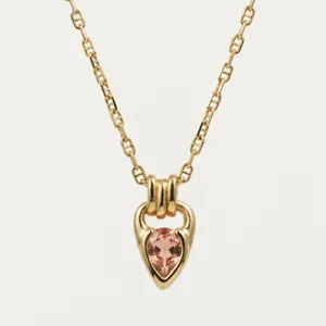 Close-up of elegant 18K gold-plated necklace with teardrop pink gemstone pendant