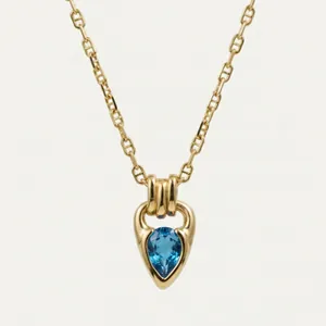 Detailed macro view of 18K gold plated necklace featuring a blue teardrop zircon
