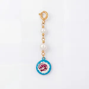 Macro detail view of a marine life series charm featuring pearls and a pink shrimp motif