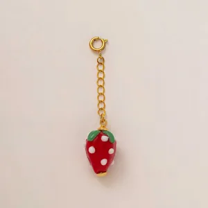 Detailed view of a red strawberry charm with gold-colored metal chain for swimwear