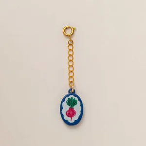 Close-up detail of a colorful radish charm from the summer fruit and vegetable collection.
