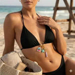 Set bikini da spiaggia nero minimalista con esclusivi ciondoli a forma di palette e stella marina.