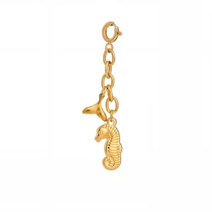 Detailed gold seahorse and fish tail charm pendant featuring a secure spring ring clasp