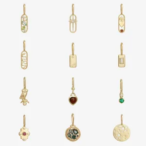 Grid display of vintage 18K gold plated charms with colored gemstones for DIY jewelry