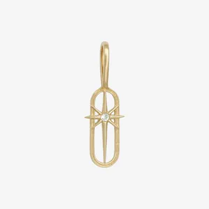 Close-up of vintage 18K gold-plated oval pendant with starburst and gem
