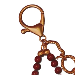 Ciondolo borsa vintage stile cinese con perline rosse e gancio moschettone bronzo