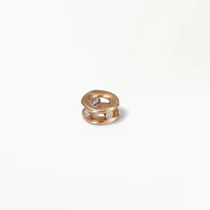 Detailed view of rose gold hollow charm bead set with purple and white zircons.