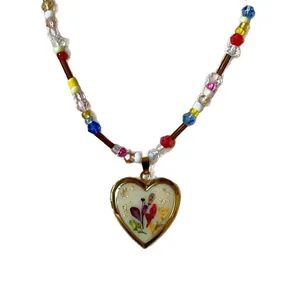 Vintage heart locket necklace with colorful floral pattern and mixed beaded chain