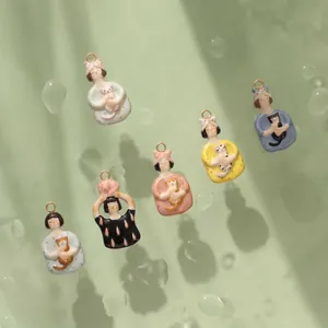 Detailed macro view of seven hand-painted ceramic cat girl charms for DIY jewelry making