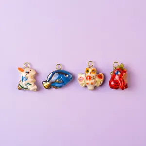 Detailed view of hand-painted animal charms including a rabbit, fish, and owl.