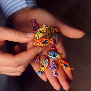 Close-up detail of colorful leopard fish charms featuring cute cat and fruit patterns