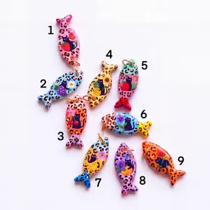 Set of nine colorful fish-shaped pendants with leopard spots and cute cat fruit motifs.