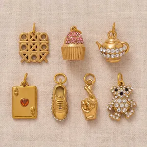Close-up view of seven 18K gold-plated DIY charms with colorful crystal accents.