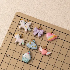 Macro shot of colorful rainbow unicorn and cloud charms on a professional grid mat