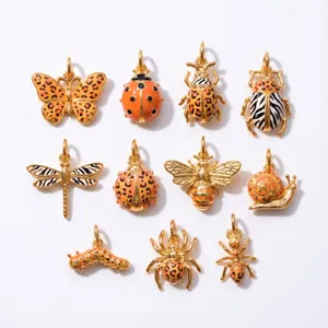 Vue détaillée de breloques insectes dorées 18K avec motifs en émail léopard et zèbre