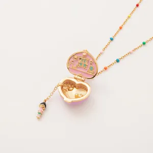 Pink gold heart locket necklace with colorful beads and miniature house scene