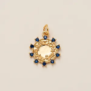 Vintage gold copper shoelace charm pendant featuring blue stones and sun sunburst pattern