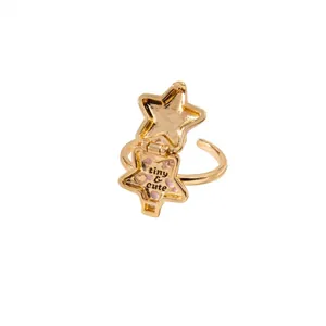 Detailed shot of a gold star-shaped locket ring featuring tiny & cute text inside