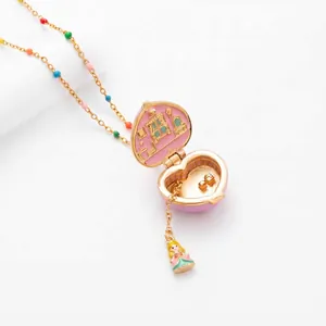 Close-up of heart-shaped locket necklace featuring a miniature dollhouse interior