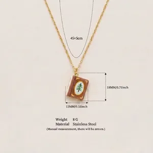 Detailed view of vintage book pendant necklace with size and material specifications