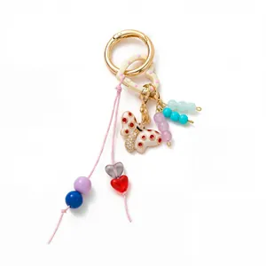 Detail view of a colorful DIY fashion keychain with butterfly and heart-shaped charms