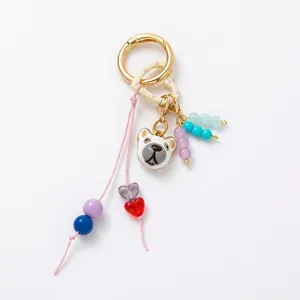 Close-up of a DIY colorful beaded keychain featuring a cute animal charm and golden ring