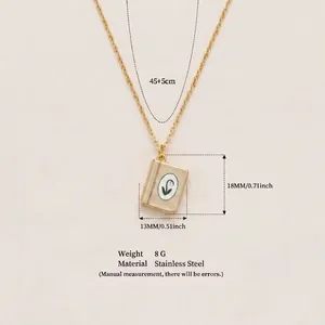 Macro view of vintage gold-tone book pendant necklace in stainless steel with dimensions