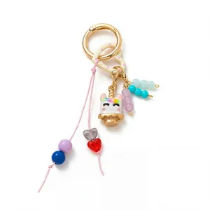 Close-up detail shot of a colorful DIY keychain with unicorn cake pendant and beads