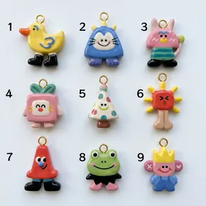 Showcase of 9 colorful cartoon animal ceramic pendants in a numbered grid layout