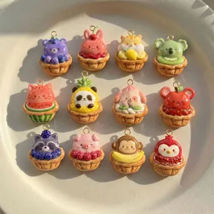 Twelve colorful resin animal and fruit tart charms displayed on a white ceramic plate
