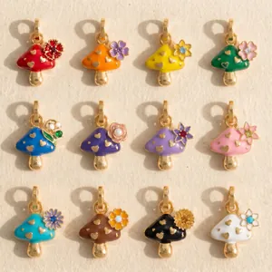 Colorful enamel mushroom charms with gold heart patterns and flower accents for jewelry.