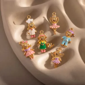 Detailed view of six colorful enamel cartoon character charms on a textured tray.
