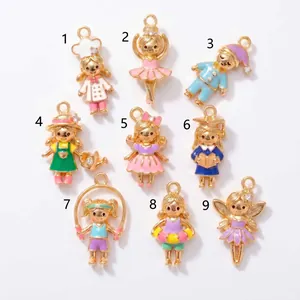 Detail view showing nine unique colorful enamel cartoon girl charms in various outfits.