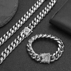 Detailed view of polished silver titanium steel Cuban link chain and matching bracelet.
