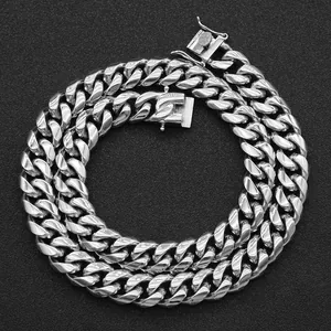Close-up of polished silver titanium steel Cuban link chain necklace for hip-hop style