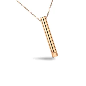 Close-up shot of a minimalist rose gold whistle pendant necklace made of durable titanium steel