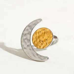 Two-tone hammered stainless steel ring with crescent moon and sun design.