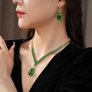 Detailed macro view of vintage emerald green teardrop necklace and earring jewelry set