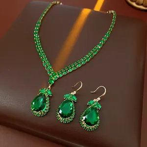 Detailed shot of luxury emerald green teardrop jewelry set with necklace and earrings.