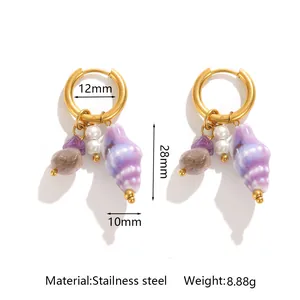 Close-up of stainless steel conch hoop earrings with shell and pearl charms with size