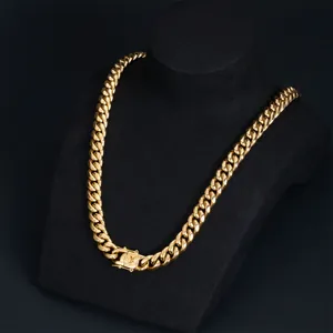 Detailed macro view of a bold gold-finished stainless steel Cuban link hip hop necklace